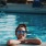 lifestyle image of a girl smiling while inside of a bright pool