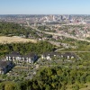 aerial of property showing nearby lush forest and nearness to downtown city skyline